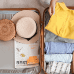 A person packs a suitcase for summer vacation